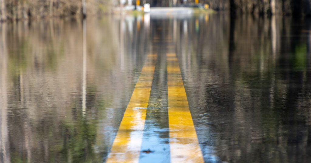 A photo of a flooded road .