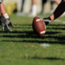 American football players ready at the line of scrimmage before a play.