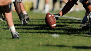 American football players ready at the line of scrimmage before a play.