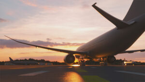 A view of a jet moving across an airfield at sunset.